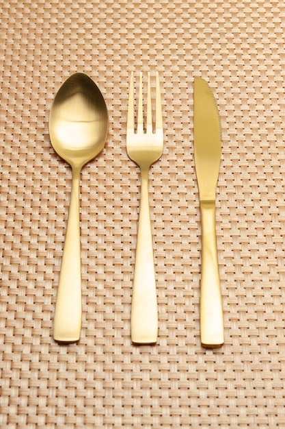 Spoon fork knife gold color isolated on gold color background