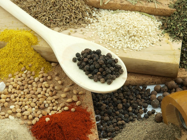 A spoon full of spices and spices with a few other spices on the table.