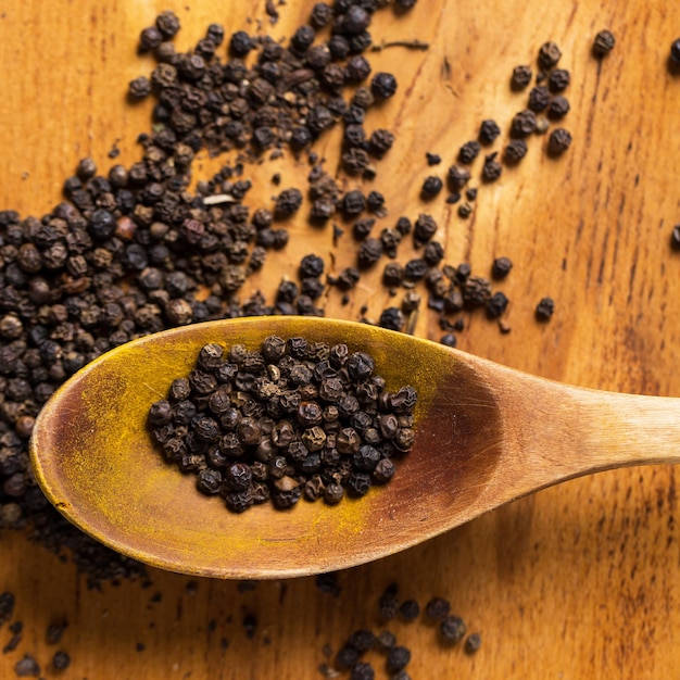 Spoon and heap of pepper on the table