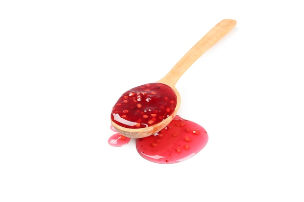 Spoon of raspberry jam isolated on white background