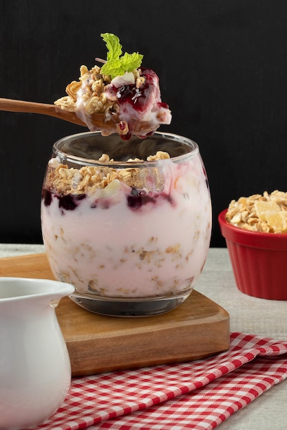 Spoon of strawberry yogurt and granola Selective focus