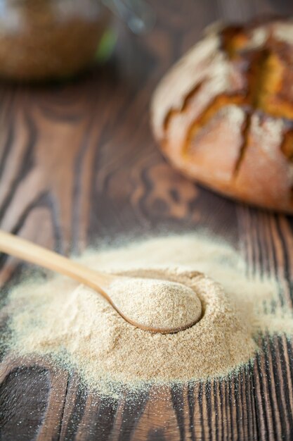 Spoon with buckwheat flour on a wooden.