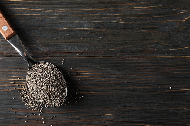 Spoon with chia on wooden