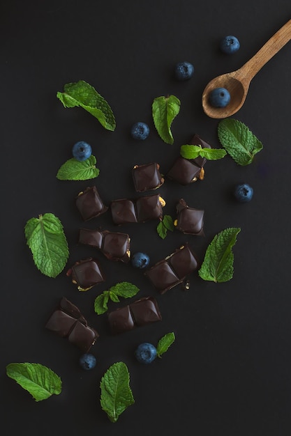 A spoon with chocolate mint and blueberries