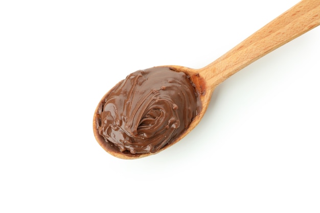 Spoon with chocolate paste isolated on white background