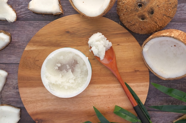 Photo spoon with coconut oil and nut on black surface