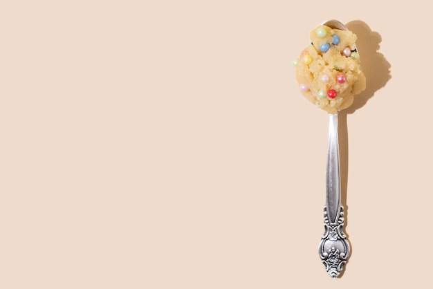 Spoon with edible cookie dough with colorful balls