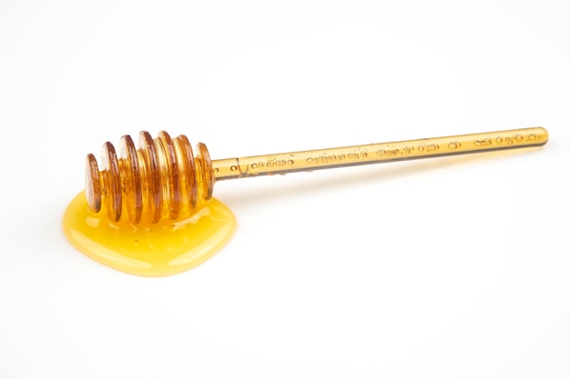 Spoon with fresh honey spilled on a white background organic vitamin food