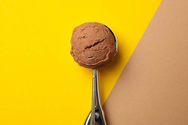 Photo spoon with ice cream on two tone surface