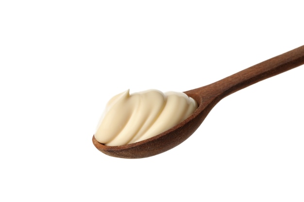 Spoon with mayonnaise sauce isolated on white background