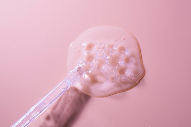 A spoon with a pink background and a pink background.