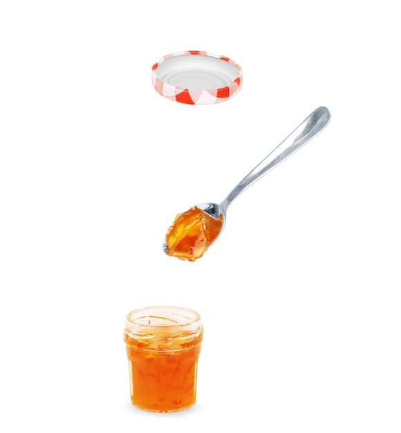 Photo spoon with tasty apricot jam on white background