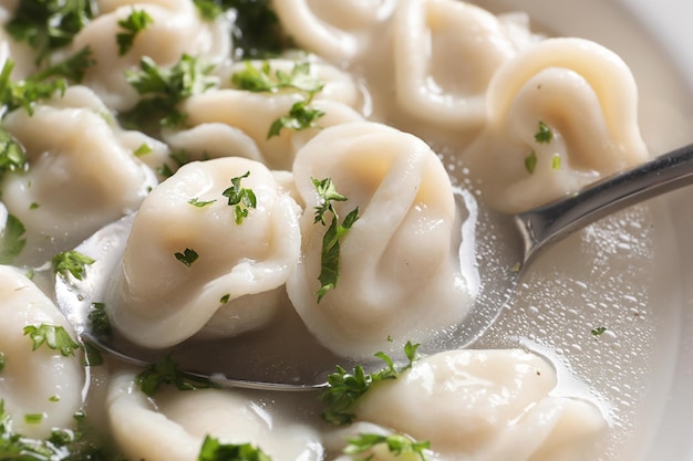 Spoon with tasty dumplings closeup