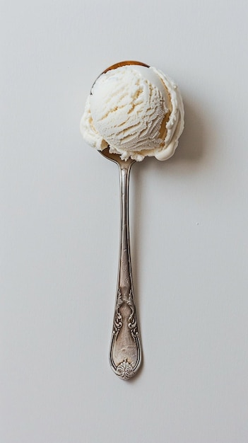 Photo spoon with white ice cream on white background copy space minimalistic