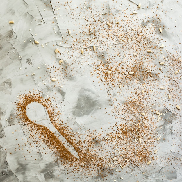 A spoonful of cocoa on a gray background