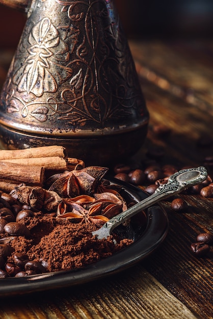 Spoonful of Ground Coffee and Spices on Metal Plate.