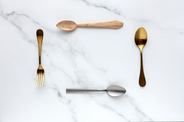 Spoons and forks on white