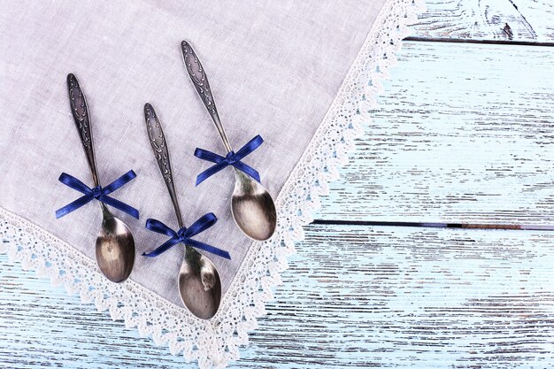 Spoons on lace napkin on wooden table