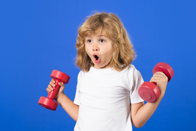 Sport activities at leisure with children Sporty kid boy holding dumbbells