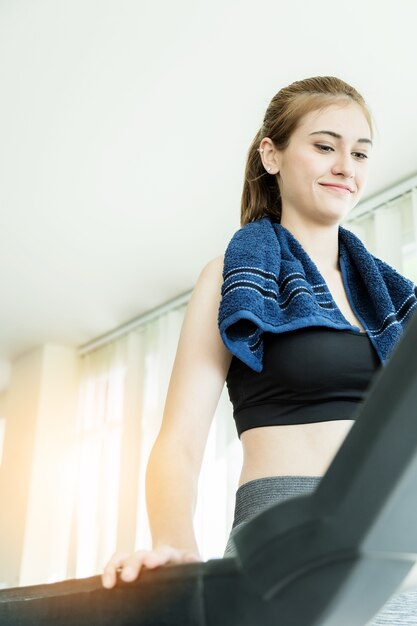 sport beautiful caucasian girl running on treadmill 