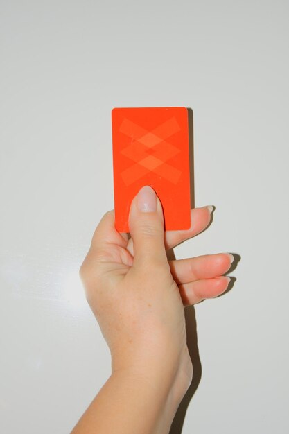 Sport caution game and people close up of referee hands with whistle showing red card