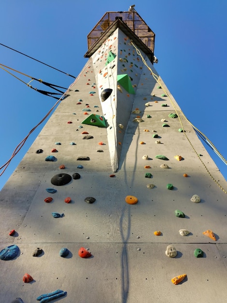 A sport climbing wall with a platform on top Perspective view from below