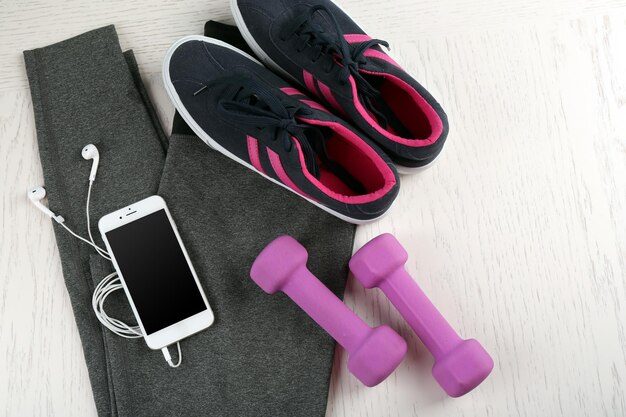 Sport clothes and equipment on wooden background