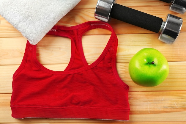 Sport clothes and equipment on wooden background