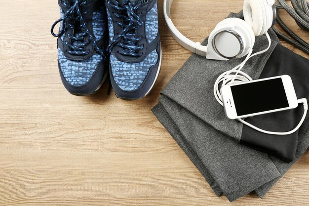 Sport clothes and equipment on wooden background