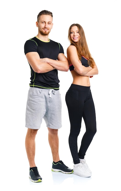 Фото Спортивная пара мужчина и женщина после фитнес-тренировки на белом фоне