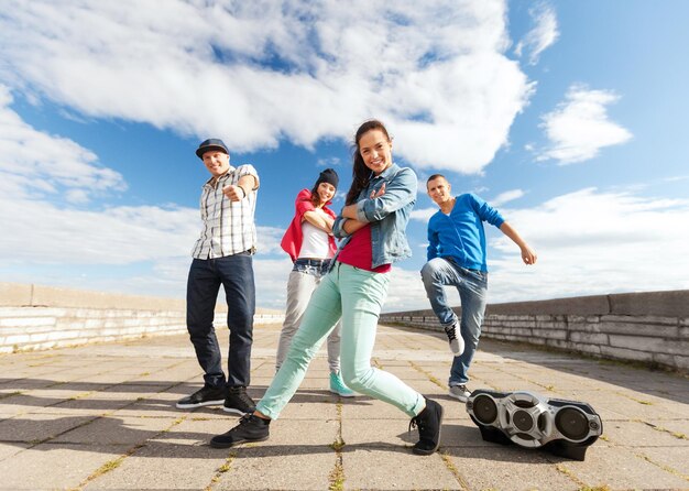 Sport, dancing and urban culture concept - group of teenagers dancing