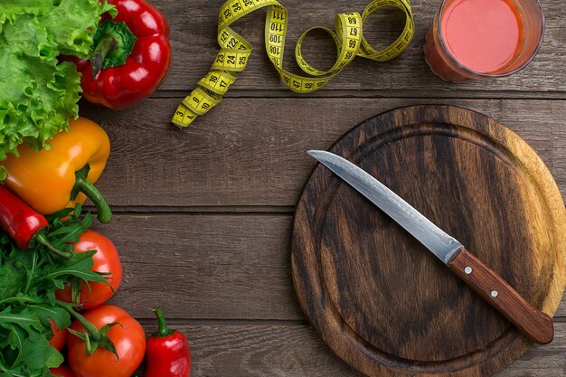 Sport and diet vegetables and centimeter peppers tomatoes salad on rustic background