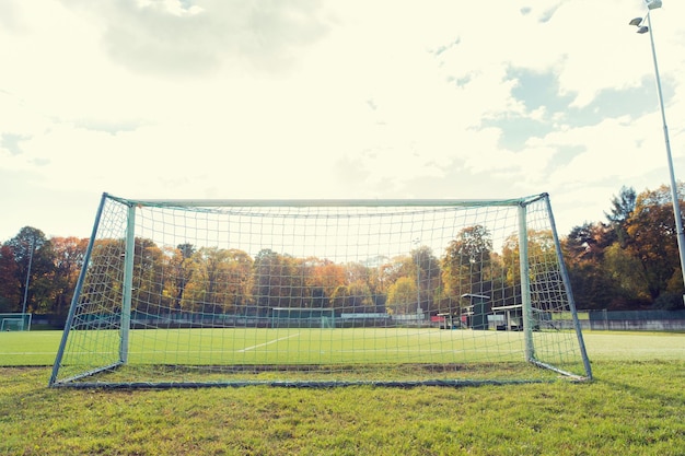 sport and equipment concept - football goal on field