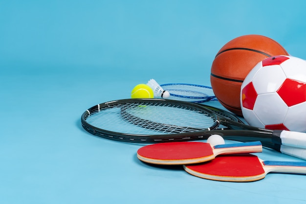 Sport equipment flat lay. Variety of rackets and balls