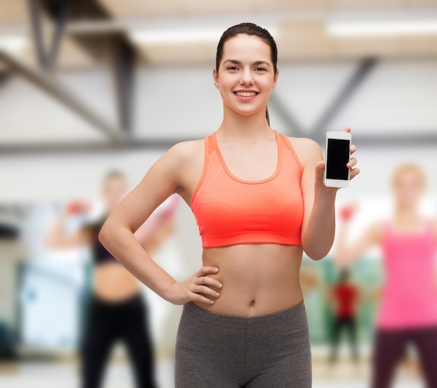 sport, excercise, technology, internet and healthcare - sporty woman with blank smartphone screen