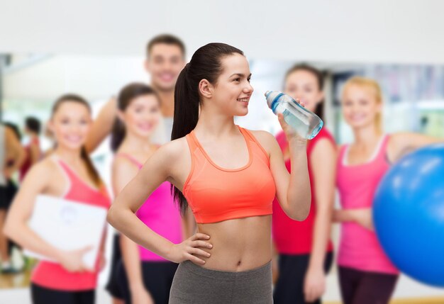 sport, exercise and healthcare - sporty woman with water bottle