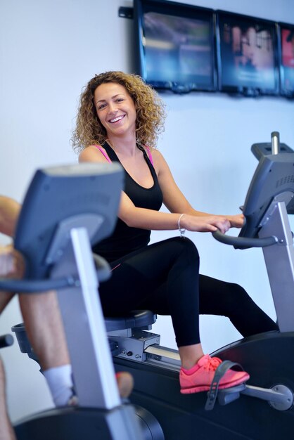 sport, fitness, lifestyle, technology and people concept - smiling woman exercising on treadmill in gym