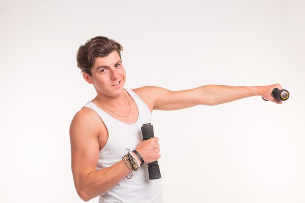 Sport, fitness and people concept - handsome athletic man with dumbbells on white background.