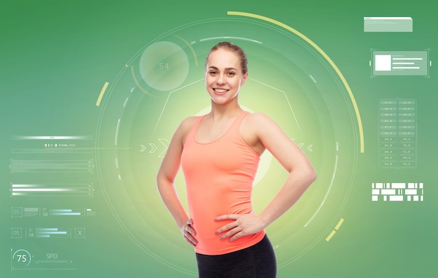 sport, fitness, technology and people concept - happy smiling sportive young woman over green background