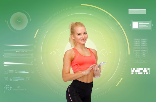 sport, fitness, technology and people concept - smiling sporty woman with smartphone over green background