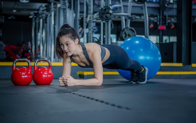 Sport fitness wear sportwear posing exercise with dumbbell equipment at gym exercise for strong make muscle body building and good healthy concept