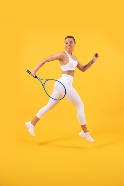 Sport game and hobby summer activity smiling young girl in sportswear run with racket