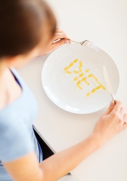 Photo sport, healthcare and diet concept - woman with plate and meds