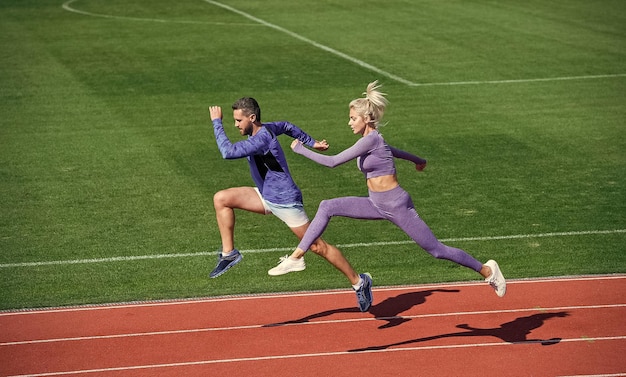 スポーツは、ランニングトラックチャレンジと競争耐久エネルギースタミナフィットスポーティな人々のジャンプ男と女のスポーツトレーナーが屋外でフィットネスカップルトレーニングを実行する上で私たちのライフランナーです