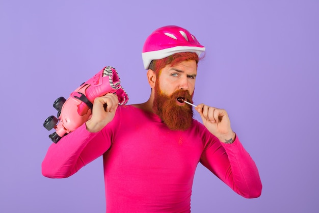 Sport lifestyle bearded man with rollerskates vacation protective helmet man in sport helmet with