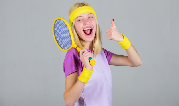Sport for maintaining health. athlete hold tennis racket in\
hand. tennis club concept. active leisure and hobby. tennis sport\
and entertainment. girl adorable blonde play tennis. start play\
game.
