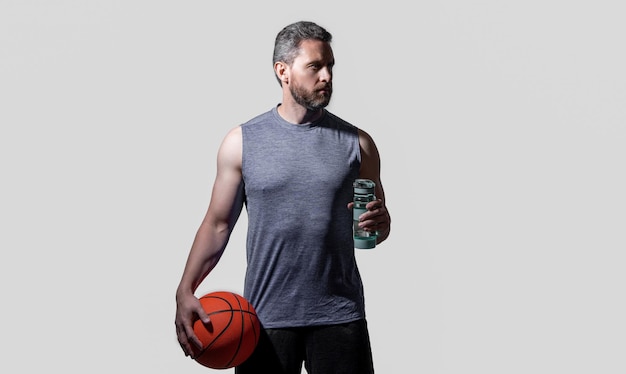 Sport man basketball player drink water in studio photo of sport man basketball player with ball