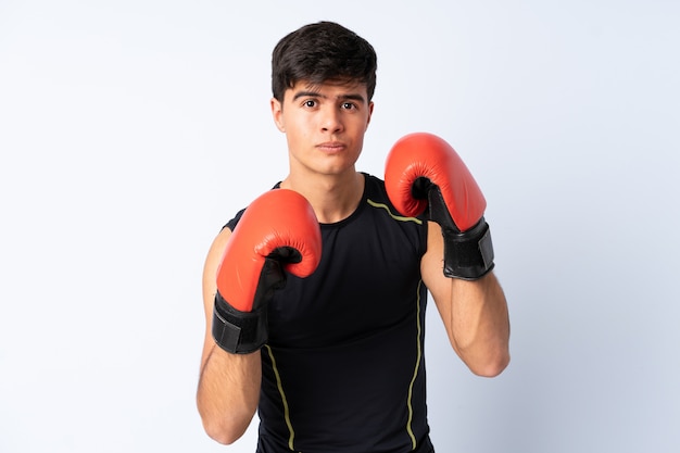 Sport man over blue wall with boxing gloves