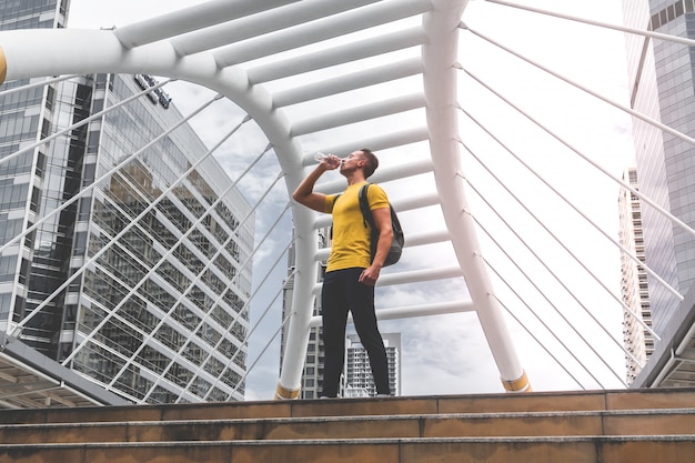 Sport Man is drinking water in a break from his work out