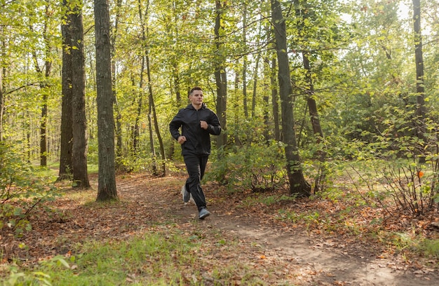 Sport Man runningon in forest Healthy active man jogging